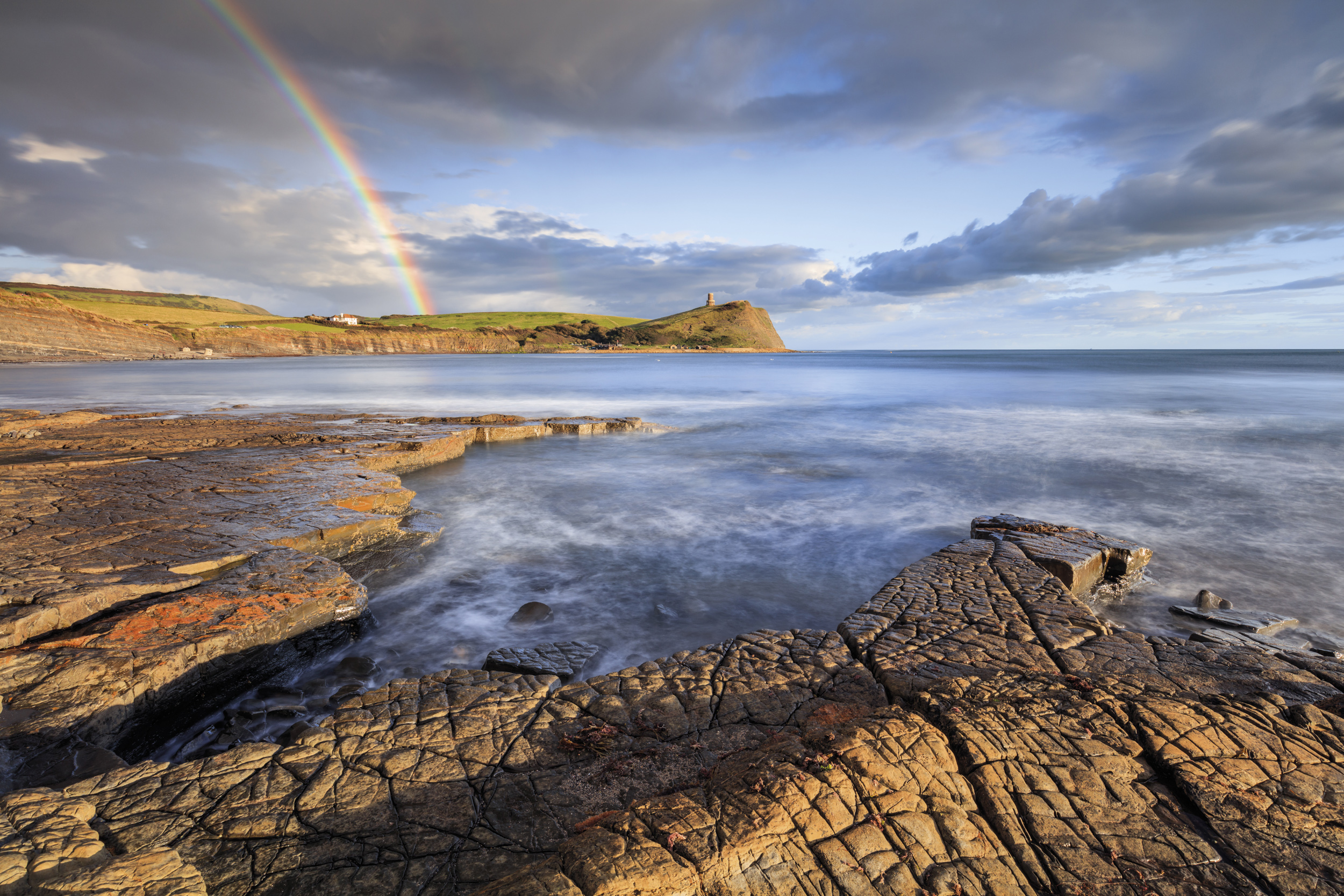 Rainbow over Kimmeridge Bay looking toward Clavell’s Tower from the western ledges.