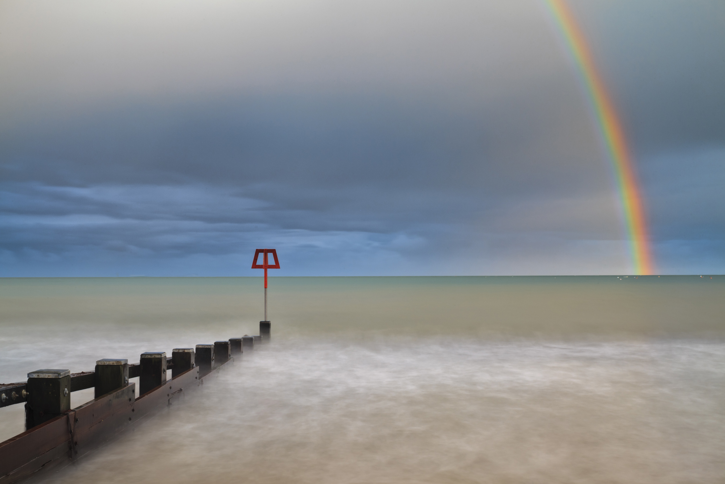 Spring is the season for sunshine and showers. Rainbow over Swanage Bay.